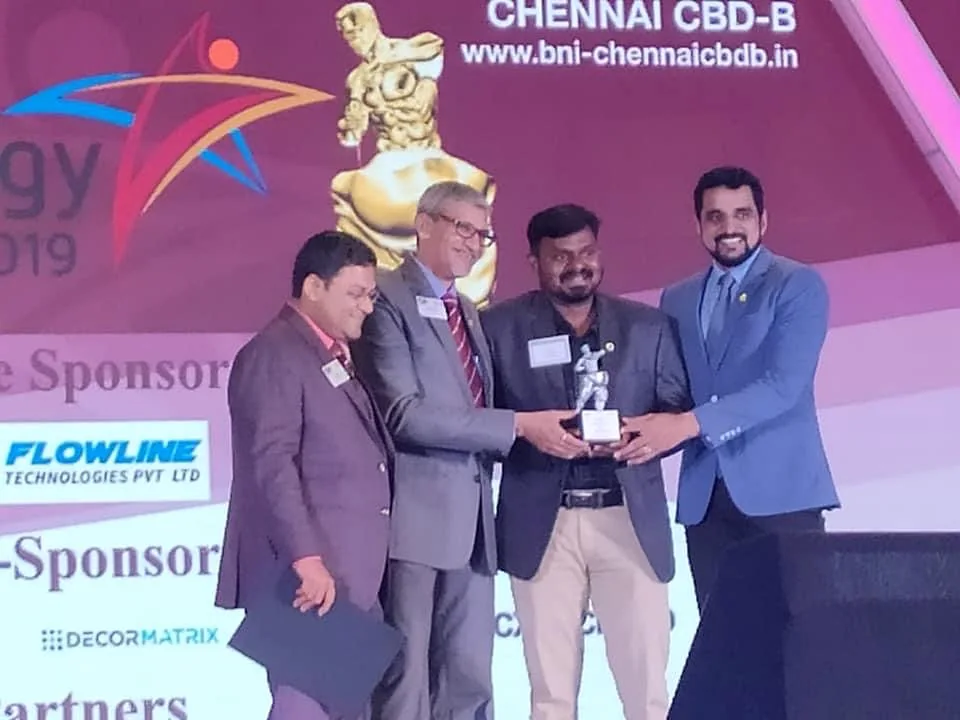 Win Landscape founder receiving a BNI Chennai CBD-B recognition award on stage, 2019